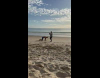 Man bend over on beach film workout