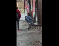 Little boy in blue jacket going one leg lunges 