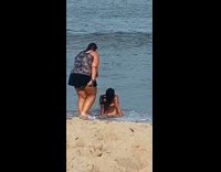 Orange bikini girl crawls lays back beach 