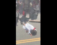 Jesus lays down on street for procession