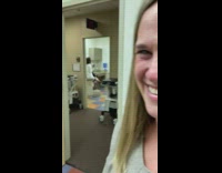 woman white coat sits on patient table