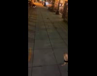 Girl yellow crocs sees rat on sidewalk 