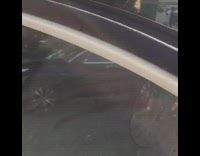 Guy rides penny farthing high wheel bike small wheel in back on street