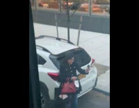 Lady takes selfies with camera white car