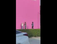 Girl puts sunglasses on grandma pink wall