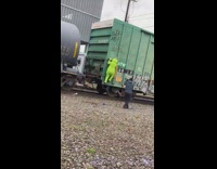 Green teletubbies climb slow train cargo