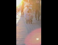Guy rides kid tricycle train station platform 