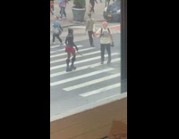 Woman doing a video shoot on busy intersection