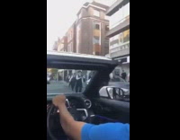 Huge crowd of London police officers run one direction down the street through traffic