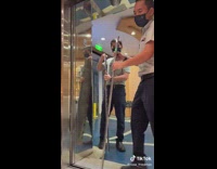 People inside elevator waiting for workers to change day plate