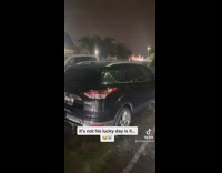 Black suv van covered under broken water sprinkler