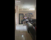 Woman in living room screaming at being shot by toy 