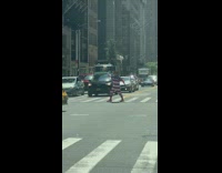 Guy in American flag costume poses in street then runs 