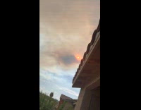 Man Shows Orange Sun on Sky from Balcony