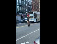 Person wearing bodysuit dances with american flag