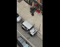 Neon green vest guy dances on sidewalk 