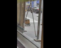 Man kicks in front of robot on sidewalk