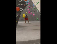 Guy plays VR in rock climbing gym 