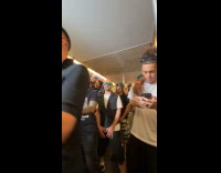 Men filming music video inside subway train