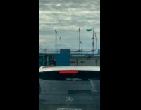 Two women swing on top of building