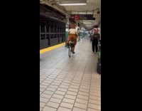 Woman brown skirt ride bike in subway