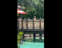 Woman white dress dance video at bridge