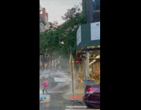 2  kids play with broken fire hydrant water  