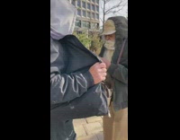 Guy helps another man light up his giant blunt