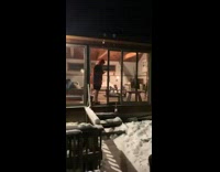Friends throw snowball at girl on couch