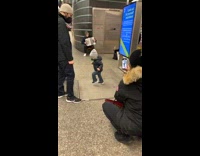 Little boy dancing to ukranian music at subway stop