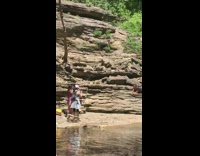 Purple leggings girl lays on stomach rock