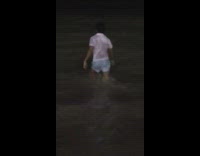 Drunk guy in ocean keeps falling in water 