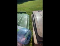 Guy inside of green trash can filled with water