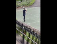 Man hat practice swinging sword at park