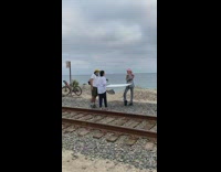 Pink cowboy hat girl train tracks beach 
