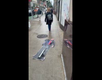 Woman drag Donald Trump standee on street