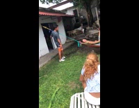 Guy pushes friend on hammock and then cuts rope with machete knife friend falls on ground