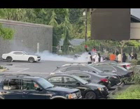 Guy sit top of car produce smoke