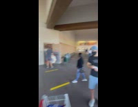 Guy with surfboards stacked on platform cart