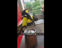 Lady points hose at coworker and scares him 