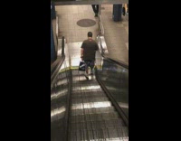 Guy walks down upward escalator 