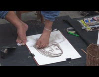 Man without arms draw portraits with feet