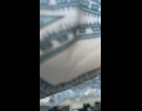 Grey cat tucked inside blanket on bed