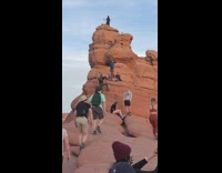 Guy hold long stick camera climb rock
