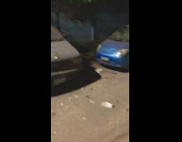 Flowers placed on parked cars street night