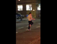 Shirtless guy skips rope in street 