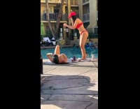 Woman in bikini lie down by the pool