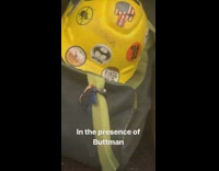 Construction workers hat has buttman batman sticker on it