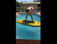 Girl falls off yellow paddle board pool 