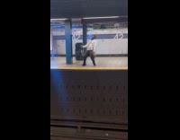 Man dancing at subway platform 
